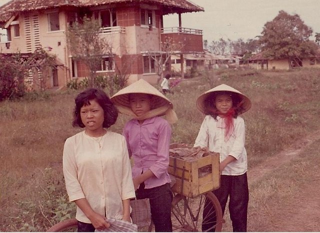 coke girls in front of old house